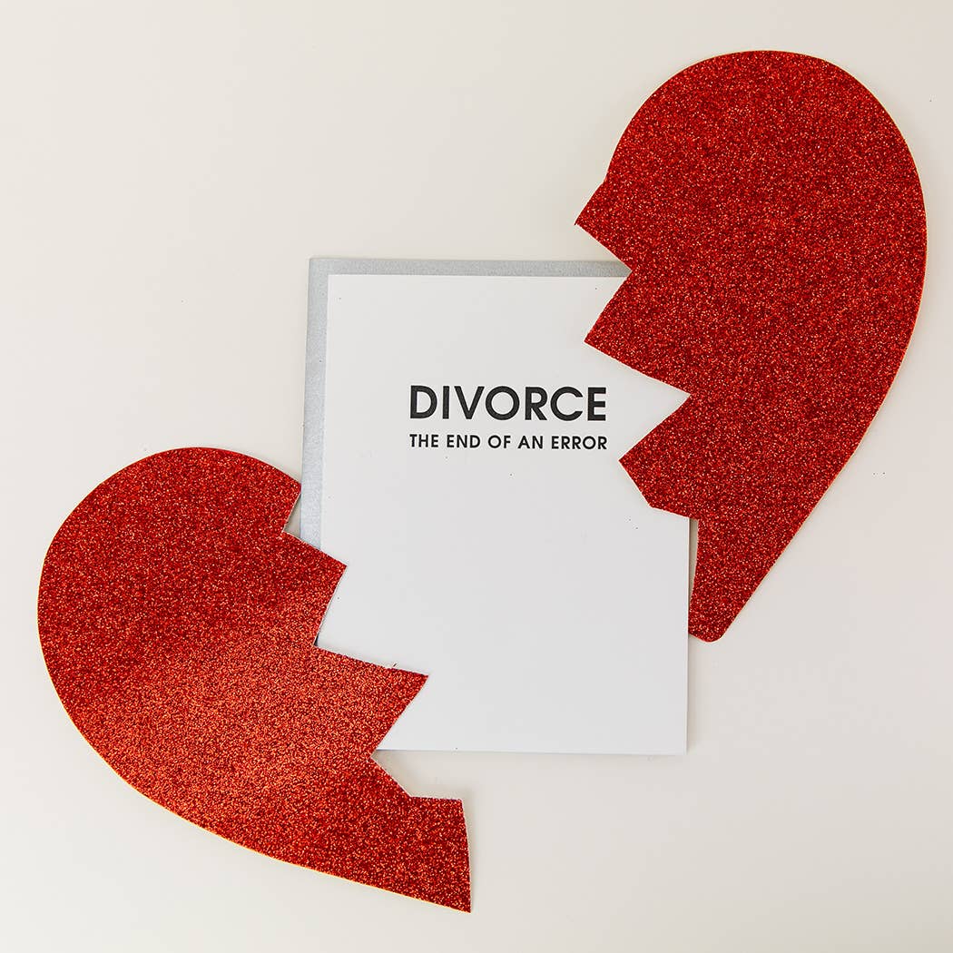 White card with "Divorce the end of an error" in black lettering. Silver envelope. Broken heart picutered in photo