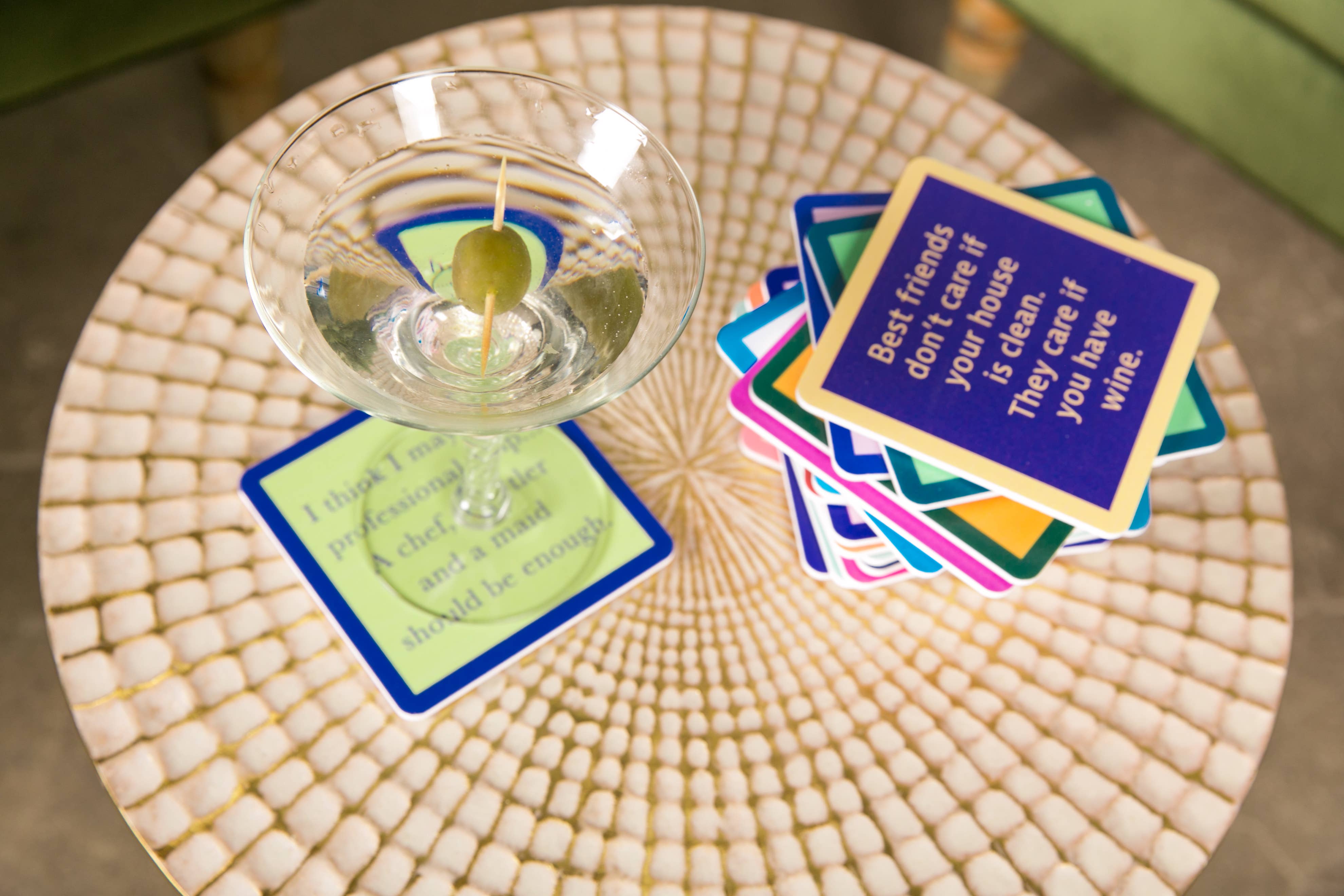 Stack of coasters on table with drink on top