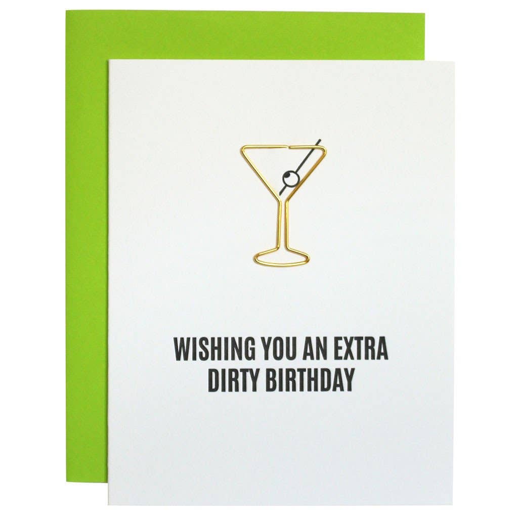 White card with a gold metal paperclip in martini shape and "Wishing you an extra dirty birthday" in black lettering. Fluorescent green envelope.