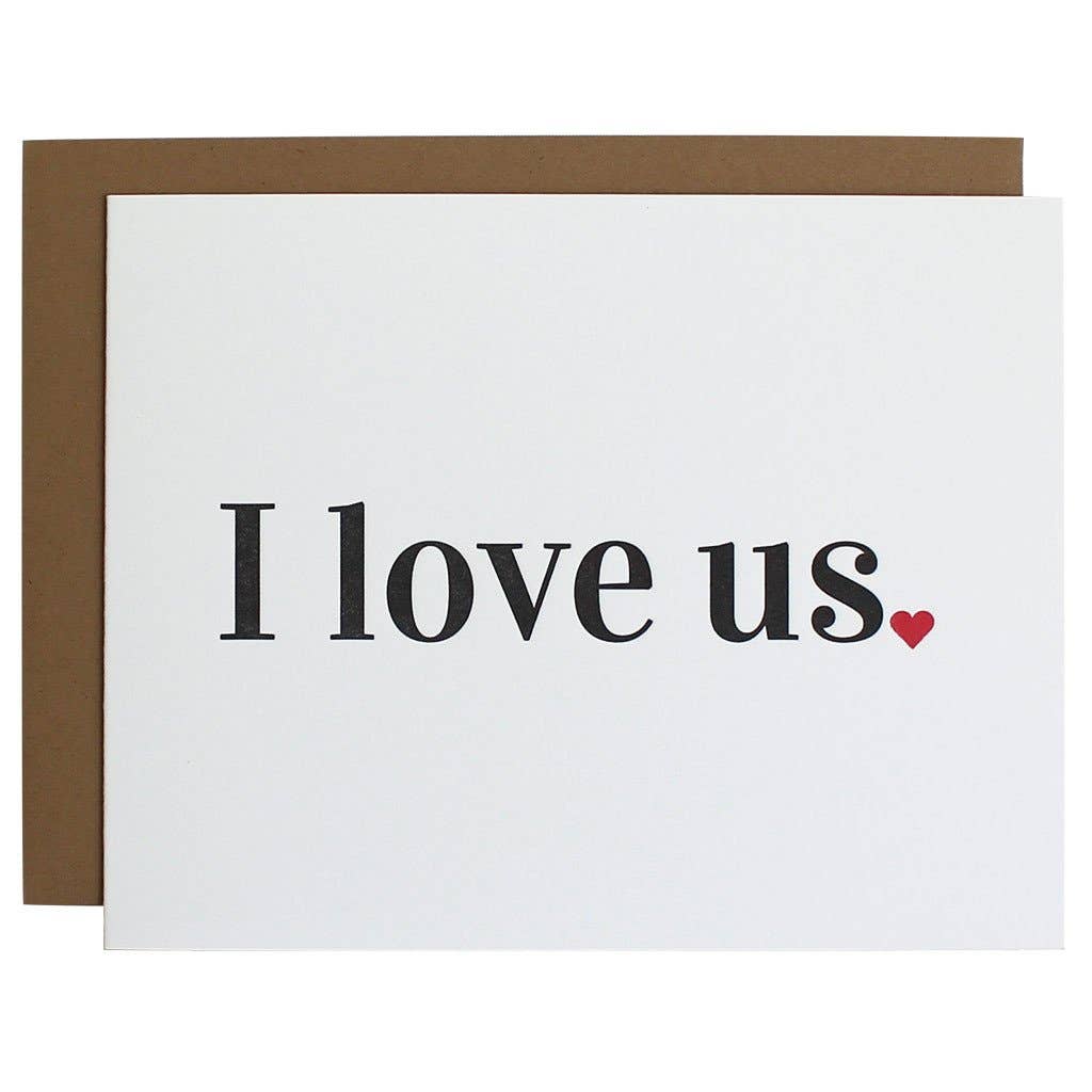 White card with "I love us" in black lettering with a red heart for period. natural brown envelope.