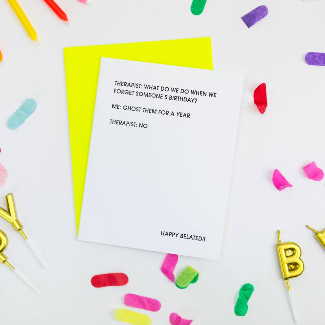 White card with "Therapist: What do we do when we forget someone's birthday? Me: Ghost them for a year Therapist: No" in black lettering.  Neon yellow envelope.