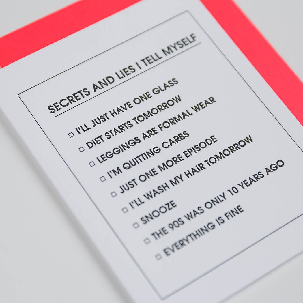 White card with black text "Secrets and lies I tell myself- I'll just have one glass, Diet starts tomorrow, Leggings are formal wear, I'm quitting carbs, Just one more episode, I'll wash my hair tomorrow, Snooze, The 90's was only 10 years ago, Everything is fine". Neon red envelope.