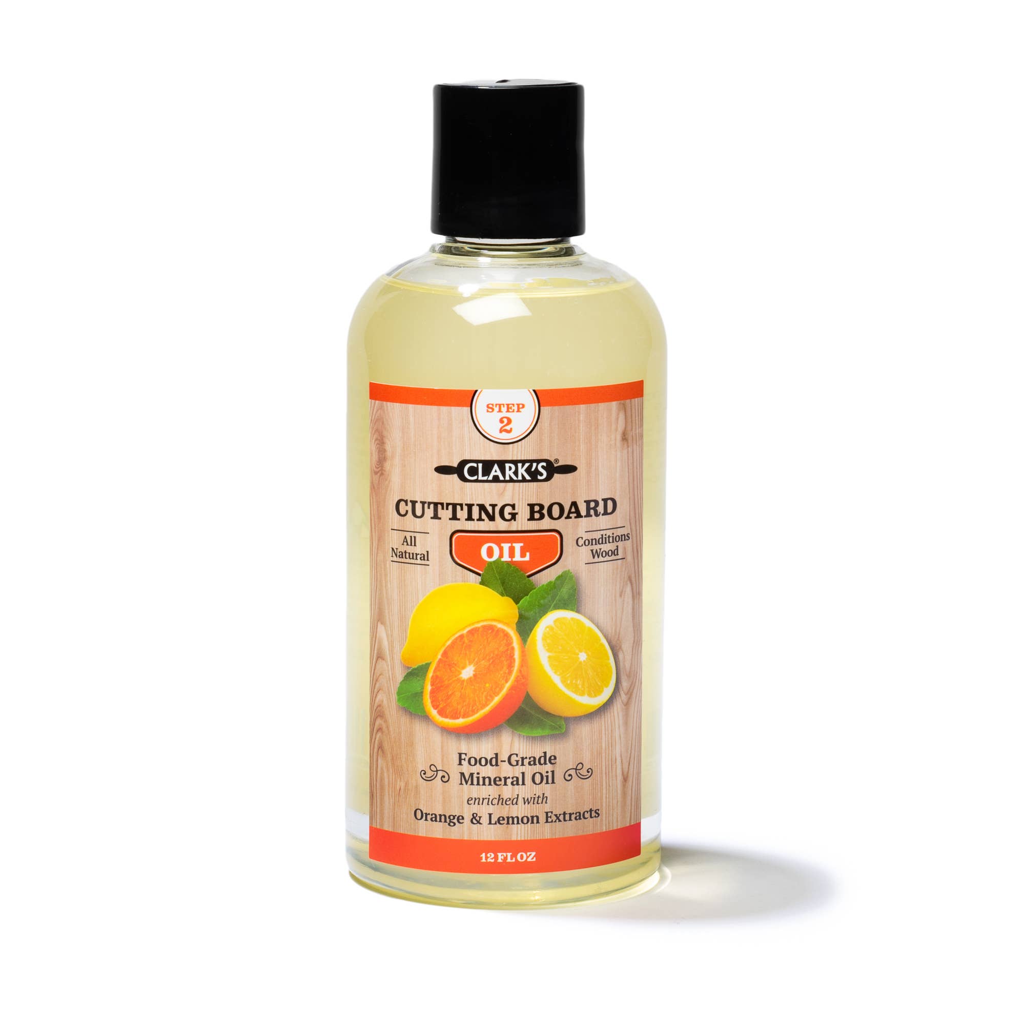 Clear plastic bottle with black lid, clear oil, and label features wood background with citrus fruits. 