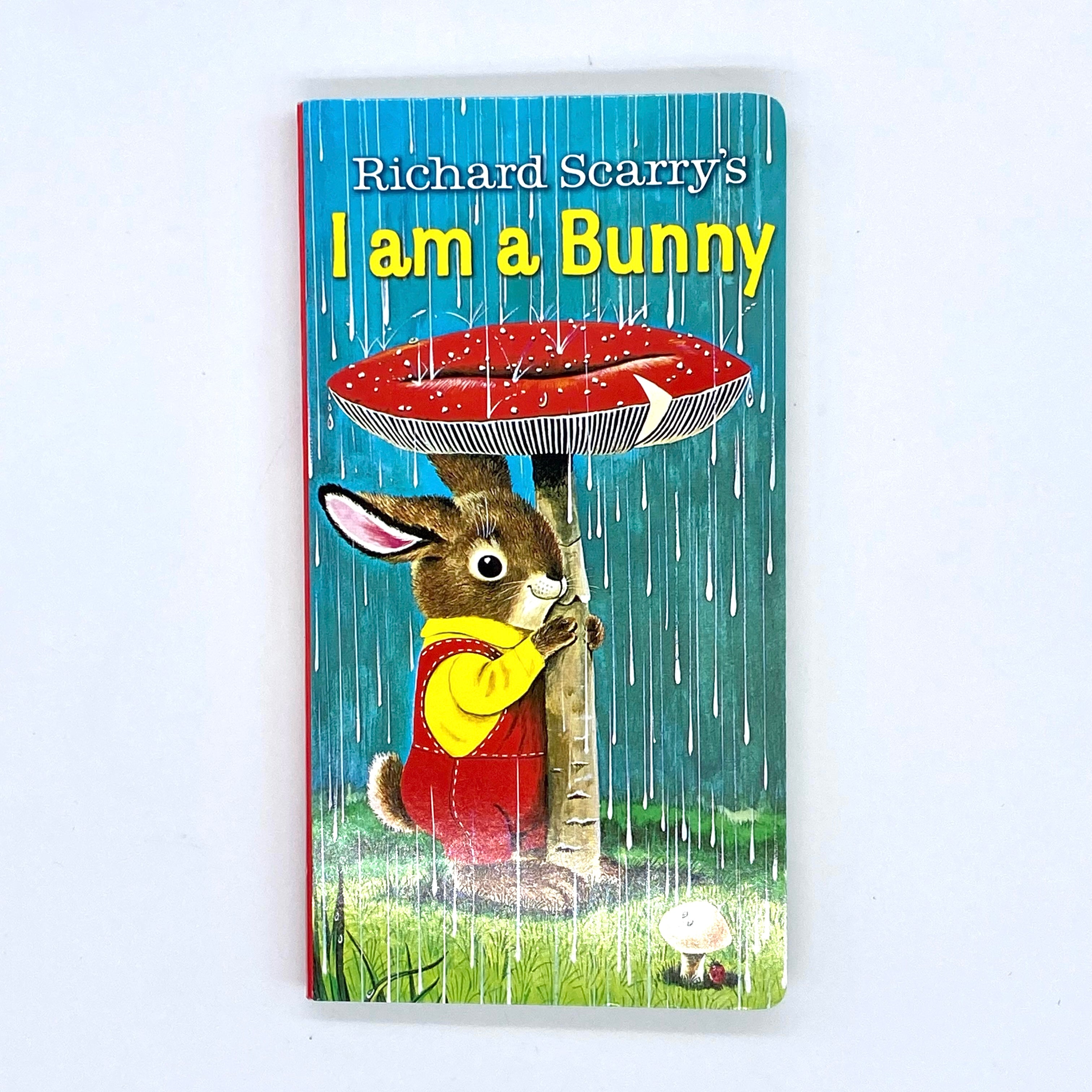 Image of front cover of "I am A Bunny" by Richard Scarry, illustration of bunny under a toadstool in the rain