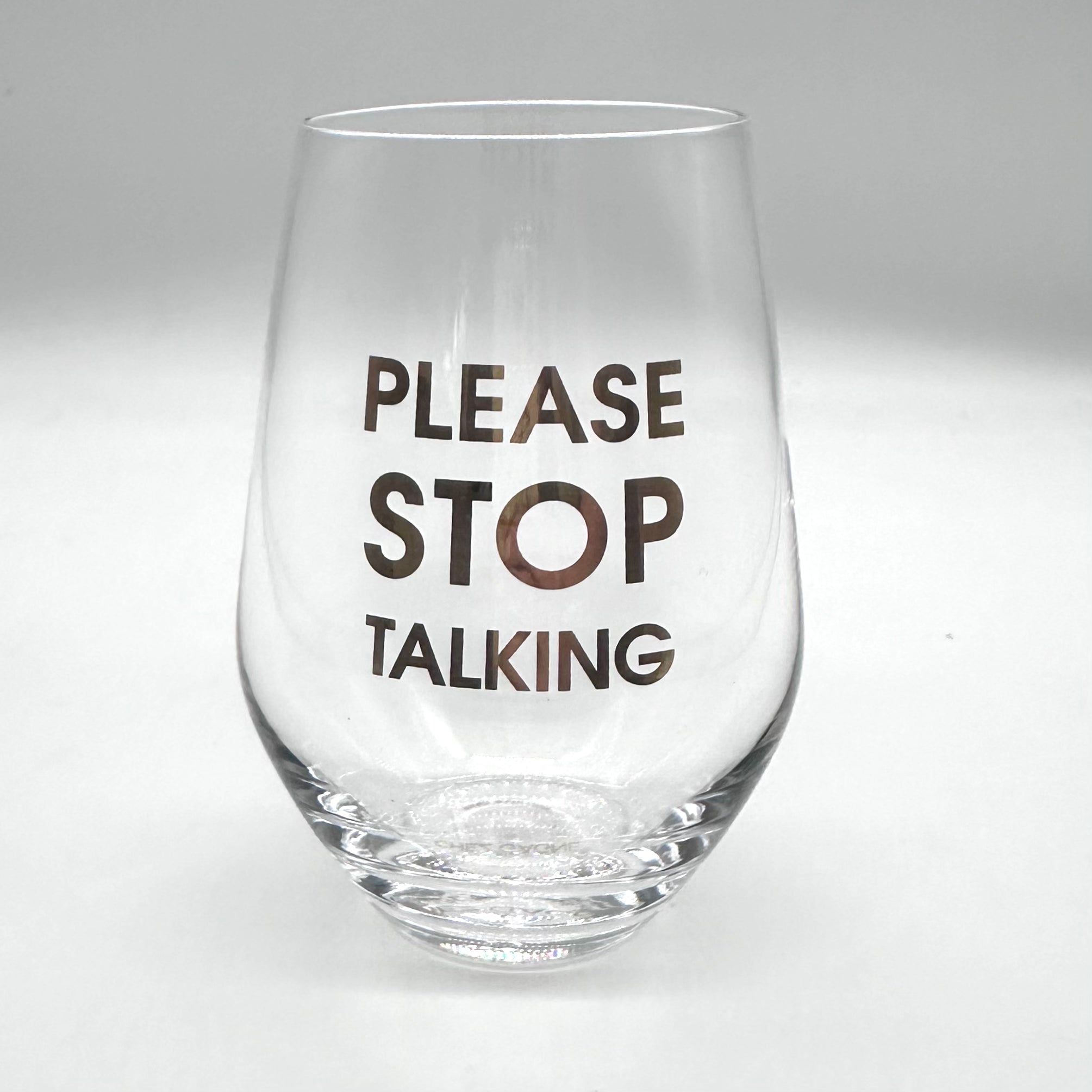 Clear wine glass with "PLEASE STOP TALKING" in gold lettering