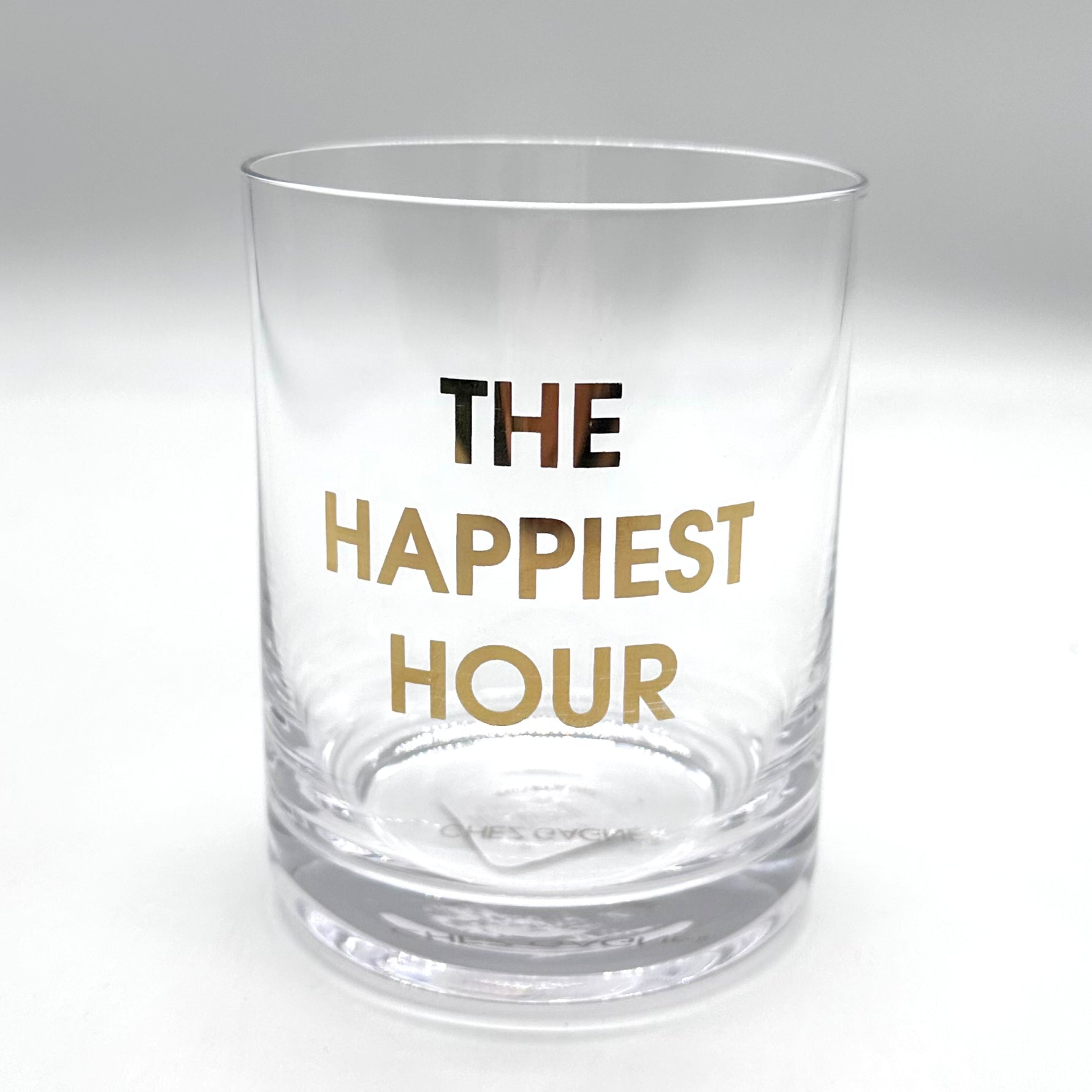 Clear rocks glass with "THE HAPPIET HOUR" in gold lettering.