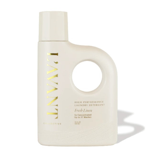 Cream colored plastic bottle with handle and cream colored lid, gold lettering states "L'avant Collective High Performance Laundry Detergent Fresh Linen"