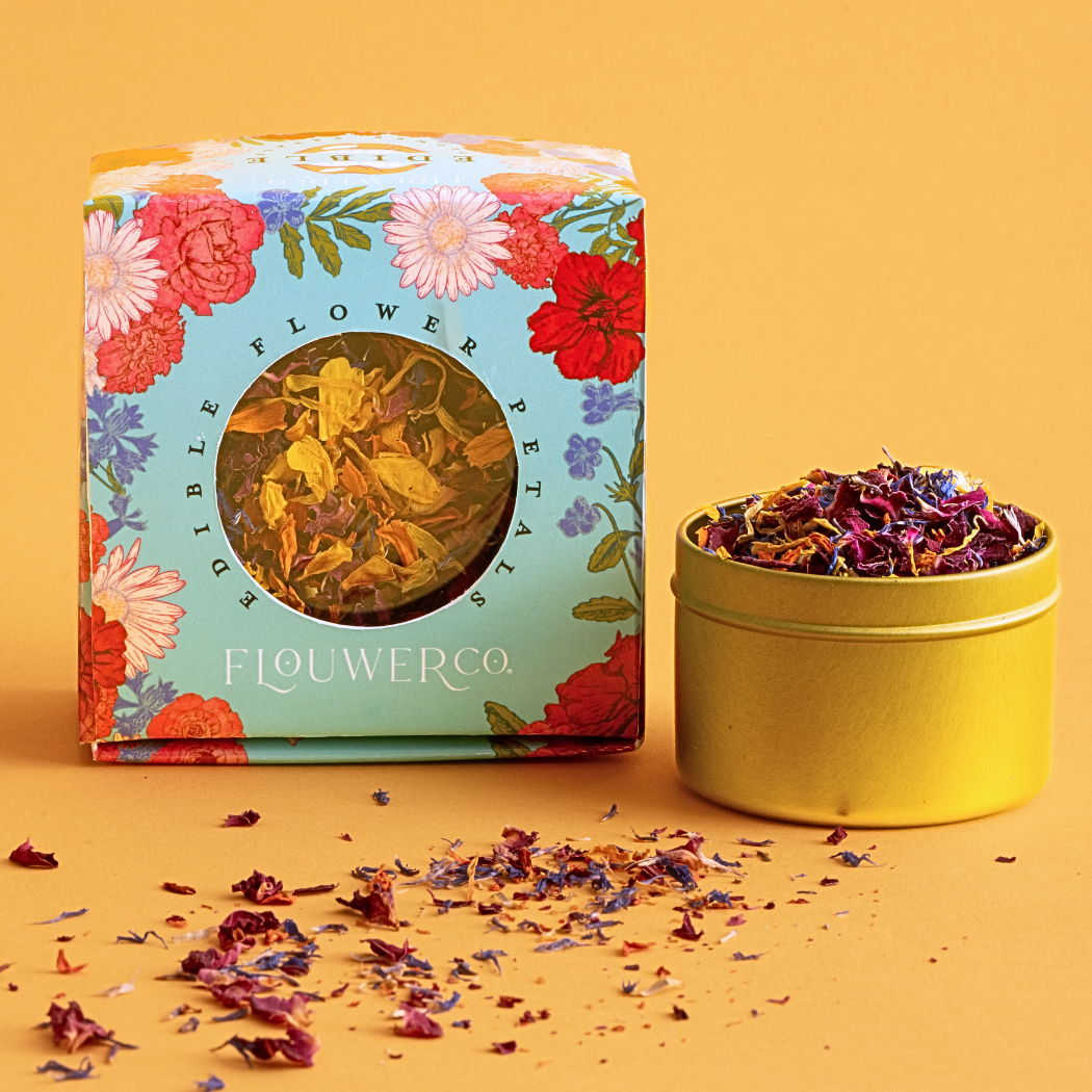 Tin full of petals and tin inside blue box illustrated with flowers