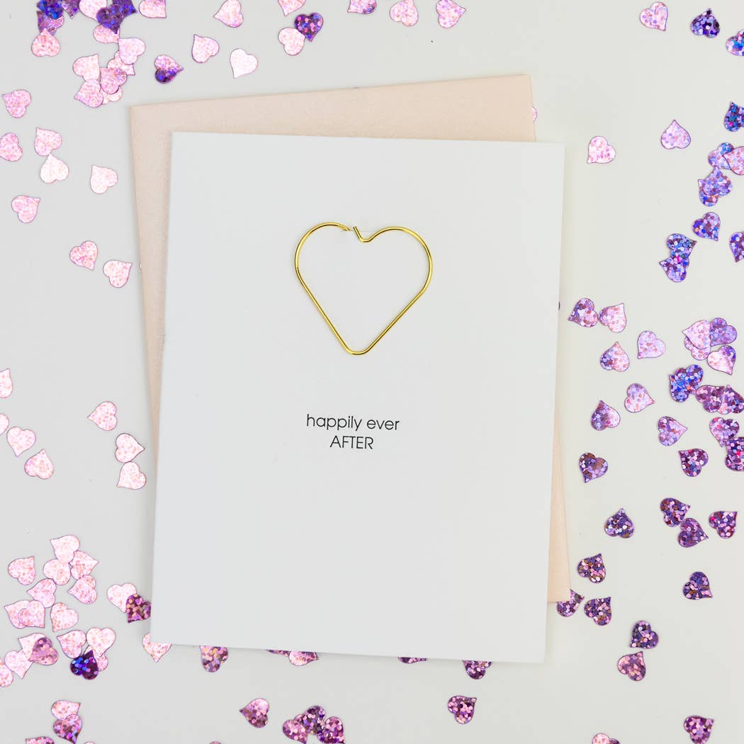 White card with gold heart shaped paperclip included and "happily ever after" in black lettering. Pearl pink envelope.