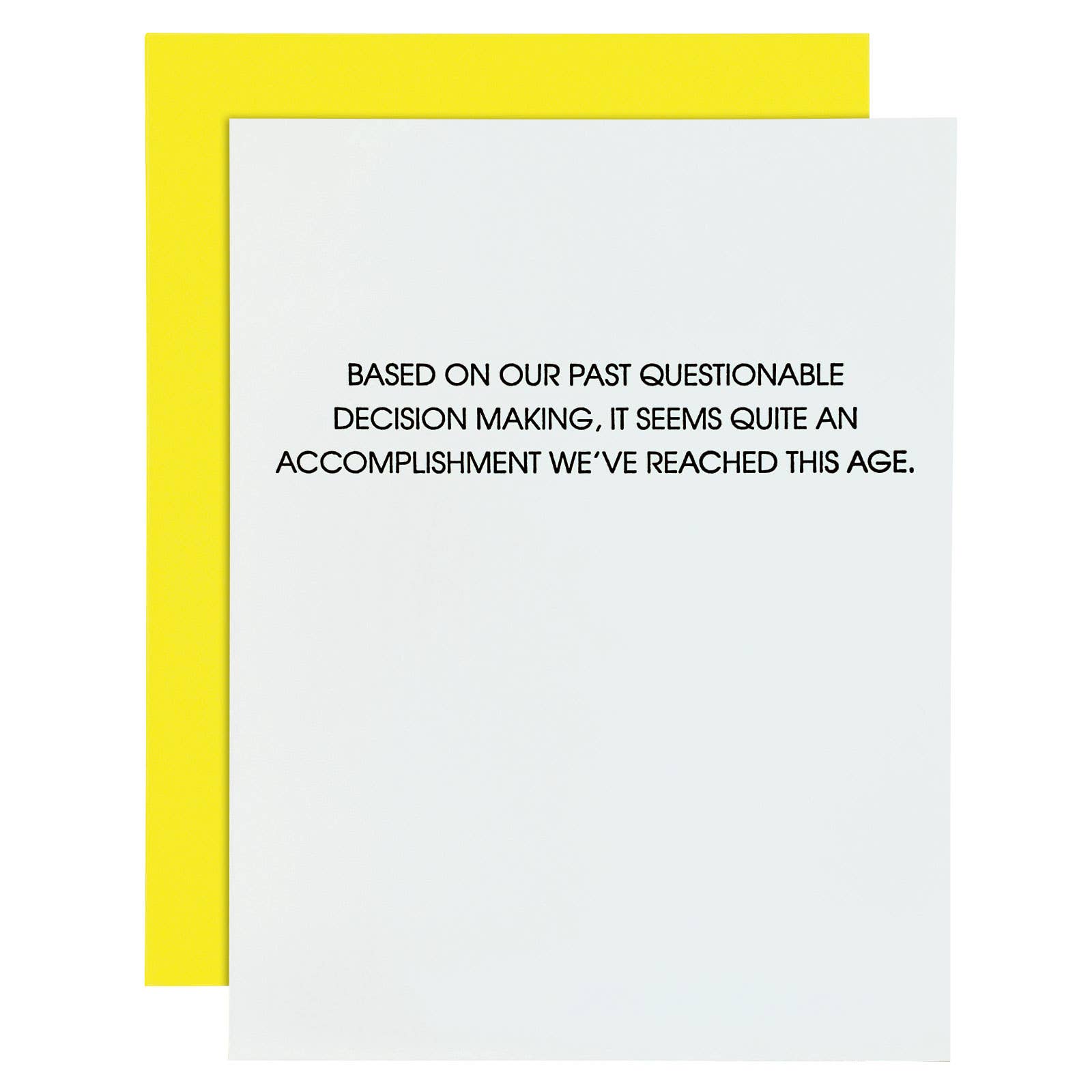 White card with "Based on our past questionable decision making, it seems quite an accomplishment we've reached this age." in black lettering. Neon yellow envelope.