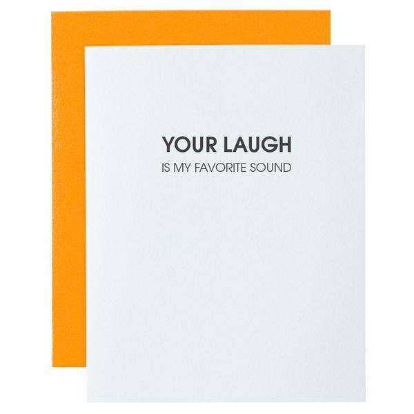 White card with "your laugh is my favorite sound" in black lettering.  Neon orange envelope.