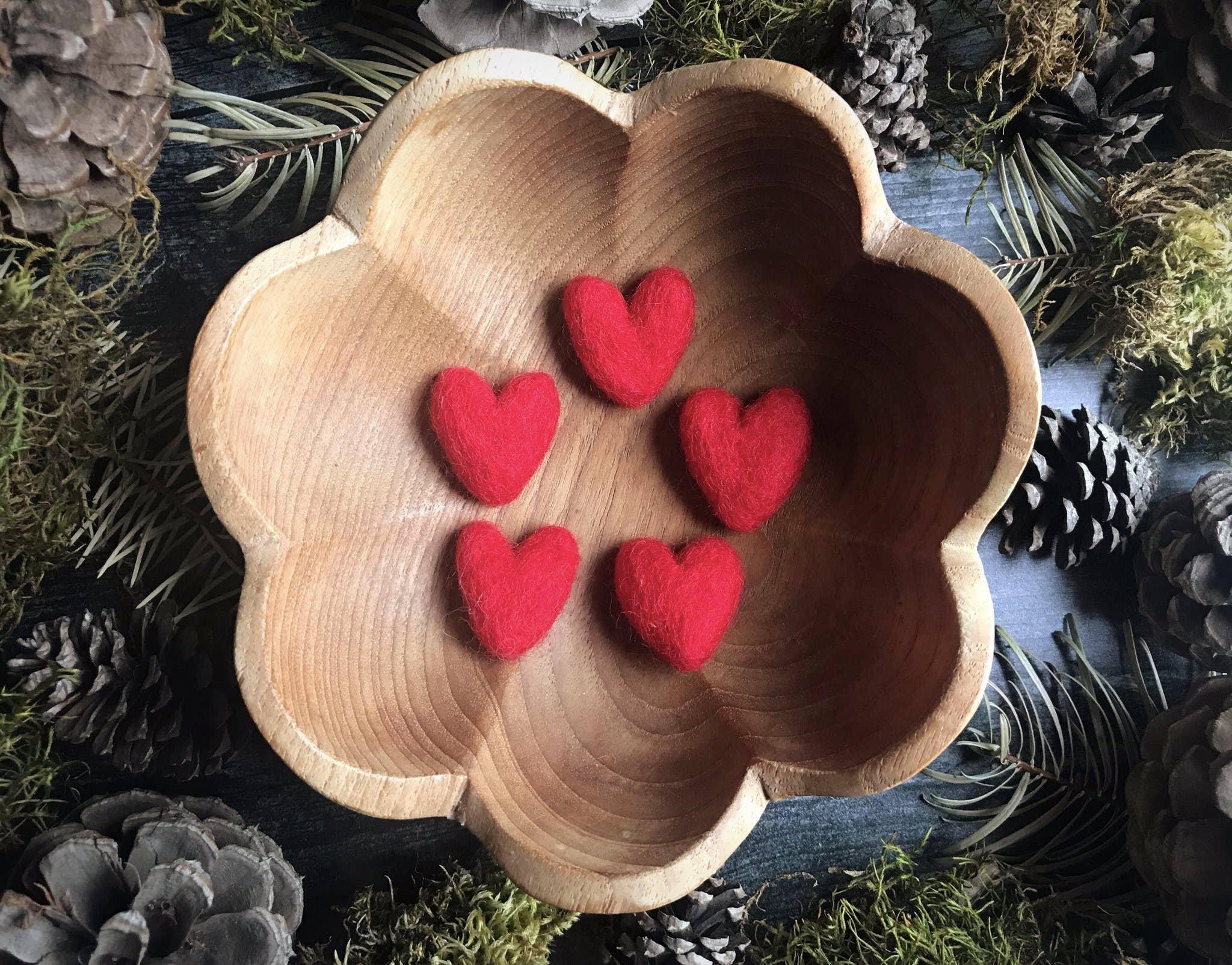 Five red felt hearts in wooden bowl