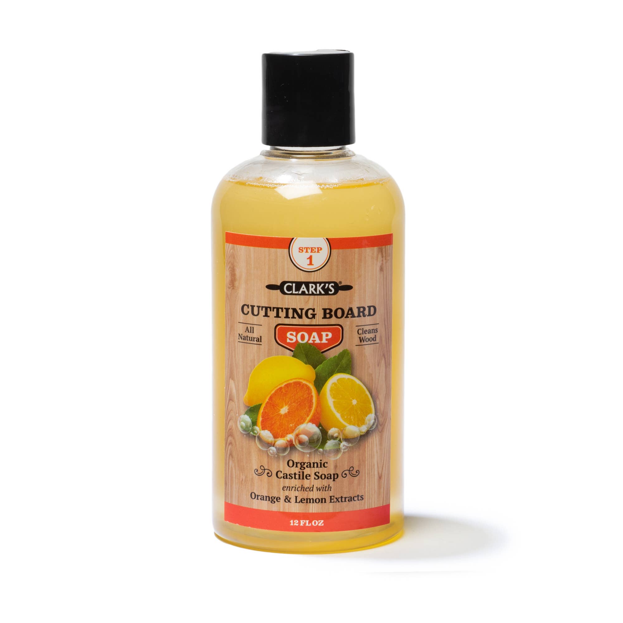 Clear plastic bottle with black lid, soap inside pale orange in color.  Label has brown wood background with citrus fruits. 