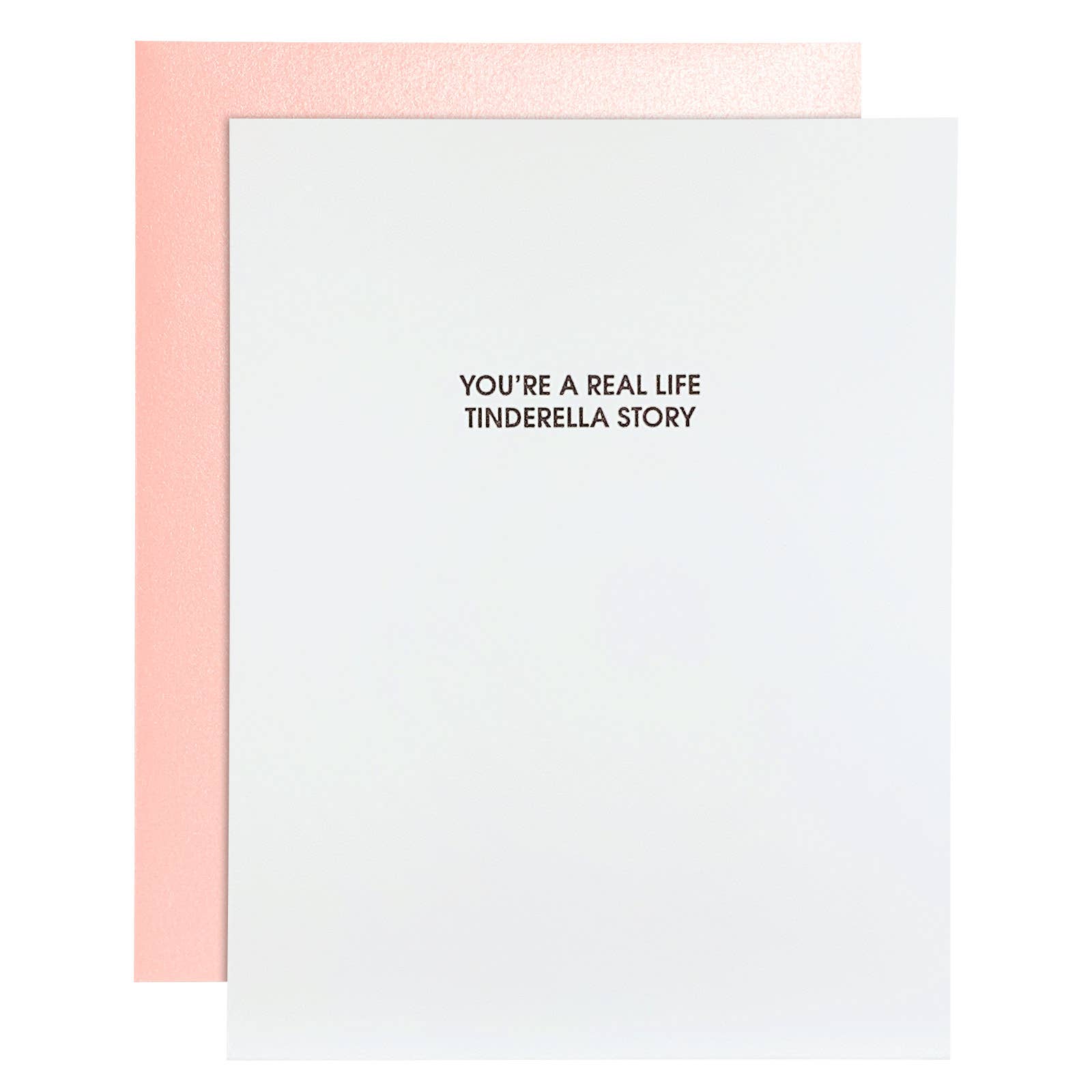 White card with black text "You're a real life Tinderella story". Pearl pink envelope.