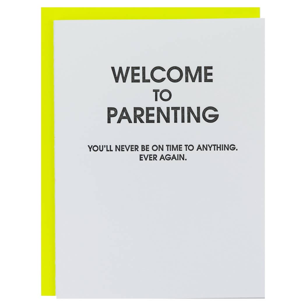 White card with black text "Welcome to parenting you'll never be on time to anything. ever again.". Fluorescent yellow envelope.