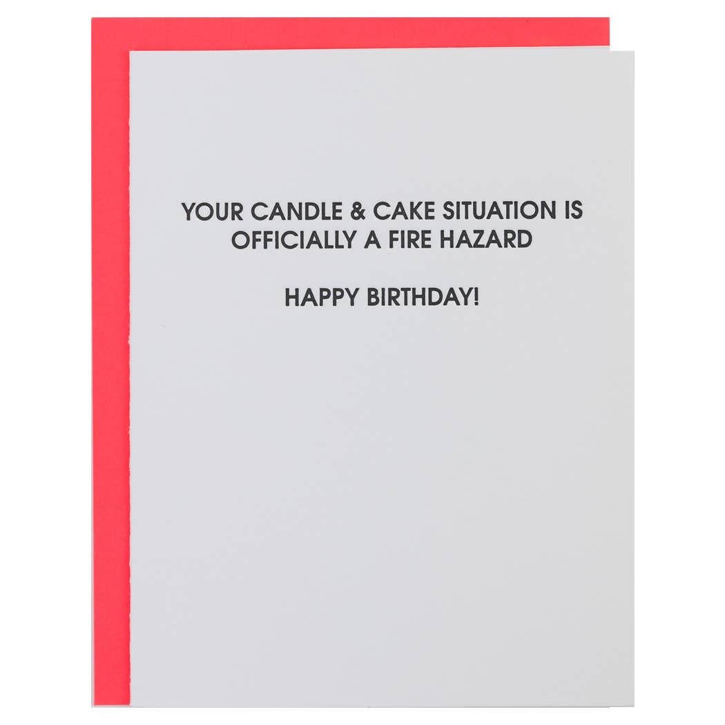 White card with "Your candle & cake situation is officially a fire hazard Happy Birthday!" in black lettering. Neon red envelope.