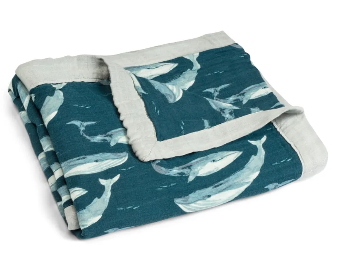 Blue baby blanket with grey edge and all over blue whale print