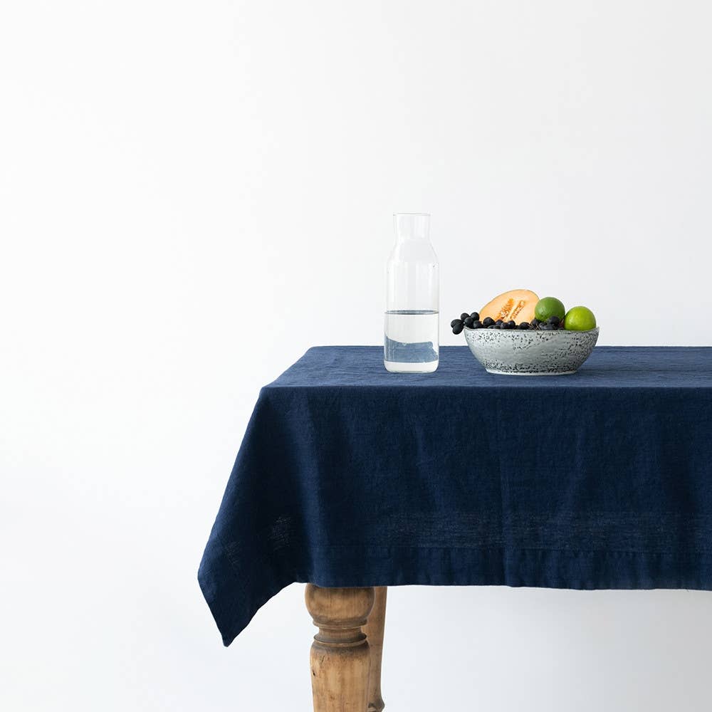 Navy blue rectangle tablecloth draped over table. 